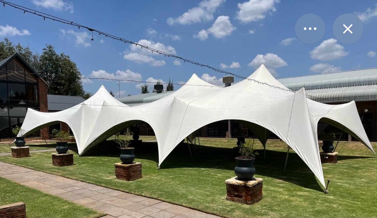 Stretch Tents — cream stretch tent canopy over a garden lawn
