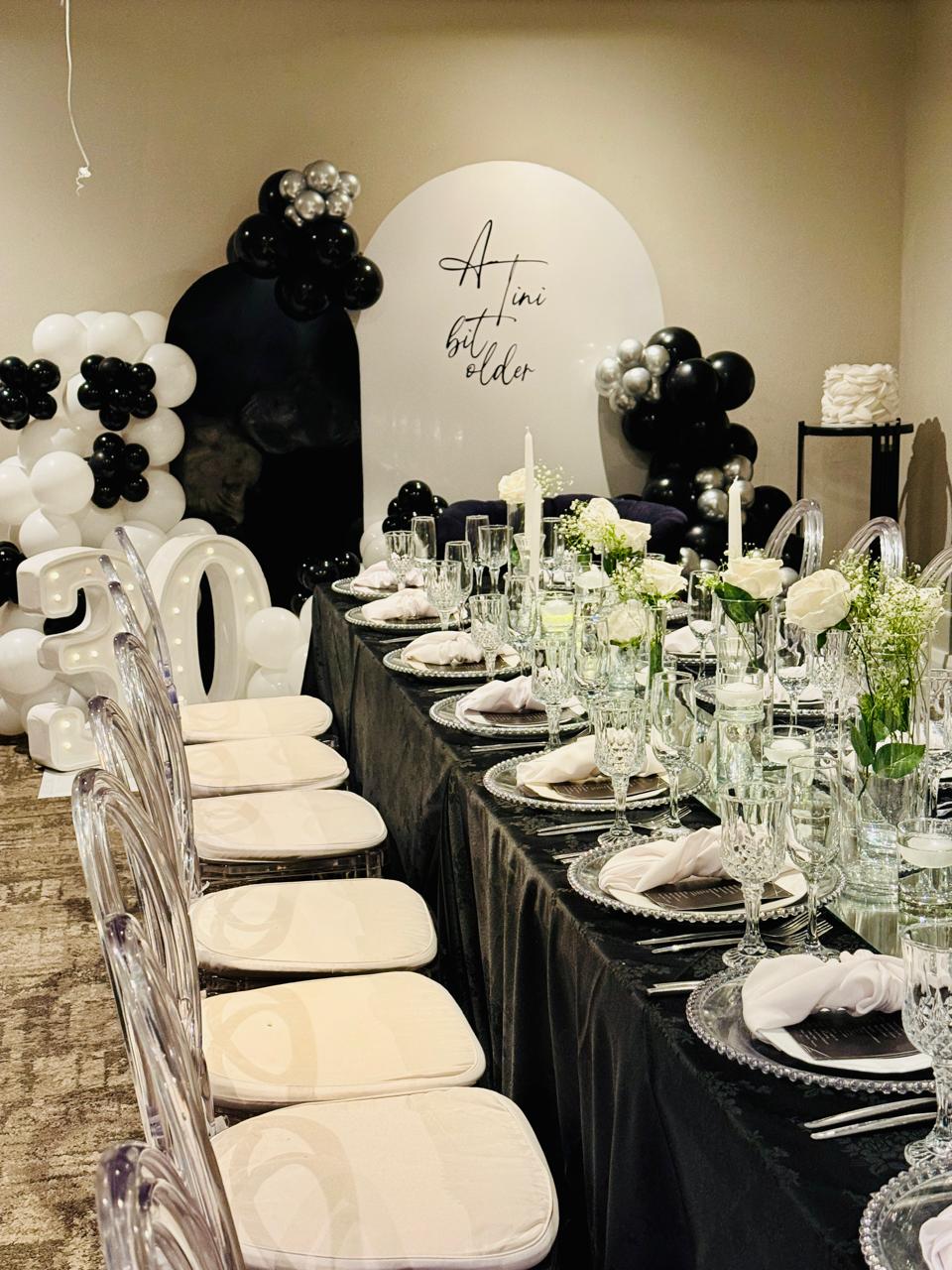 Black and silver 30th birthday table setting with crystal glassware