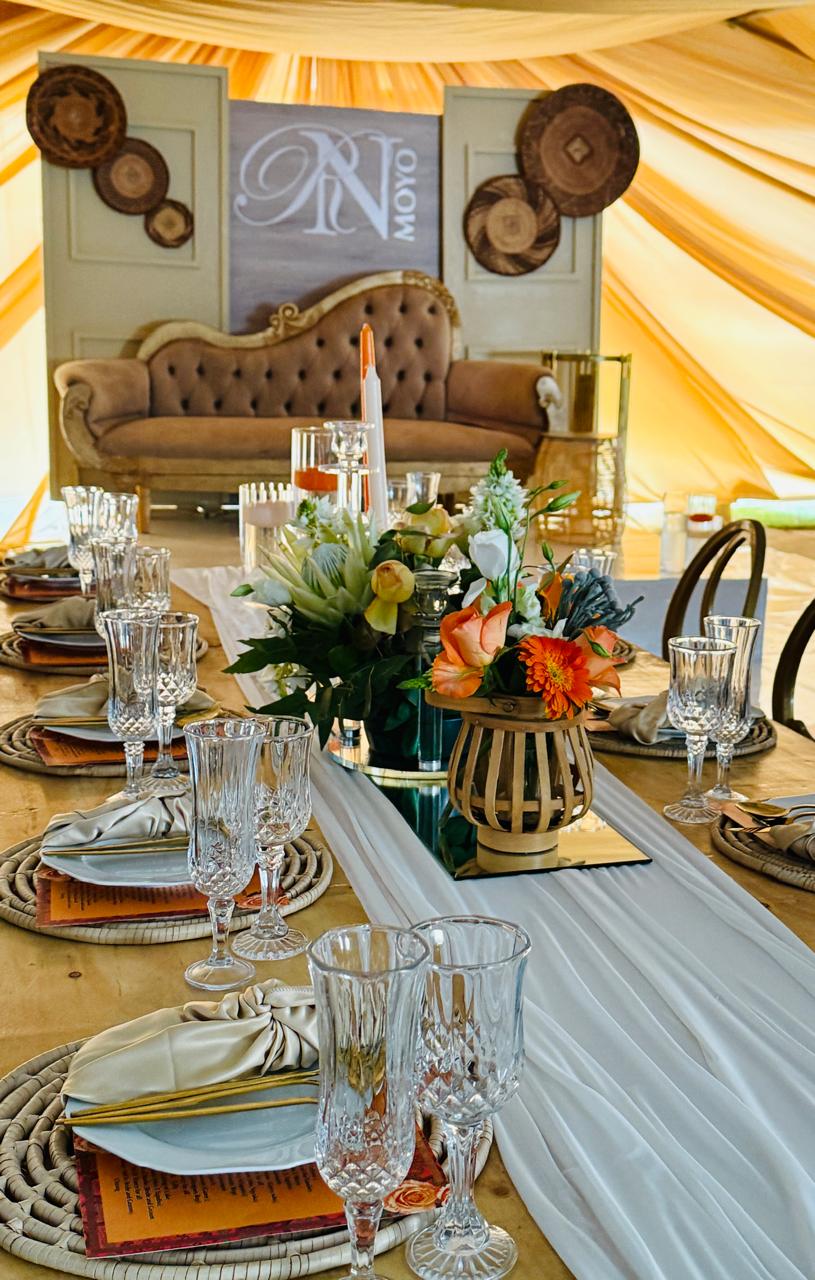 Ulwamkelo Lwabayeni monogram backdrop with vintage couch and floral table setting