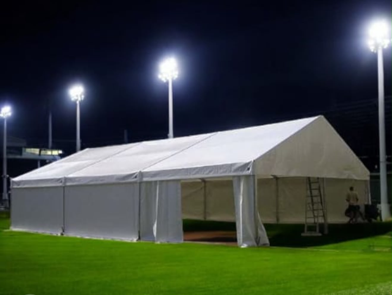 Frame Tents — large white frame tent with side walls at night
