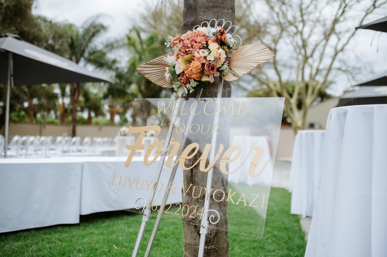 Acrylic gold 'Welcome to our Forever' wedding signage with floral detail